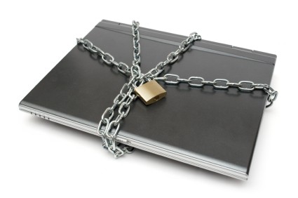 Laptop with heavy chain and padlock.
